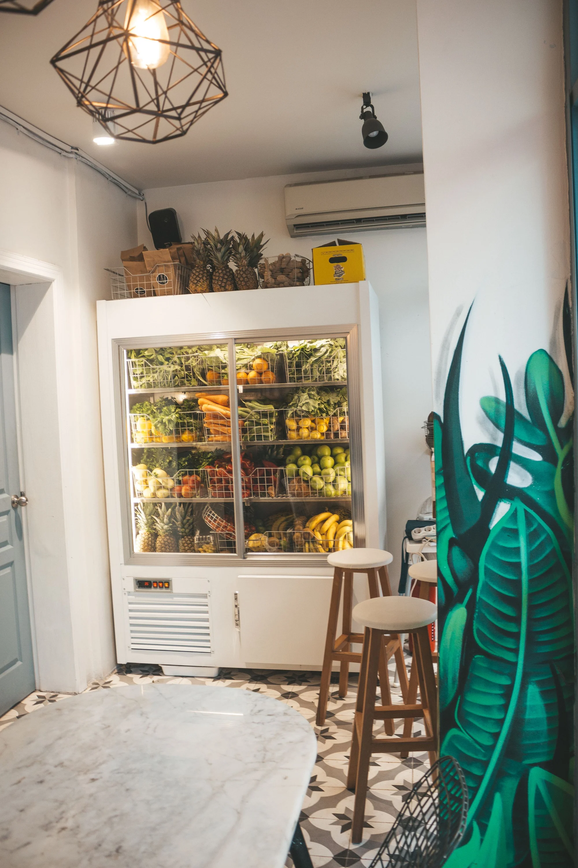 Glass-fronted refrigeration cabinet filled with fresh produce
